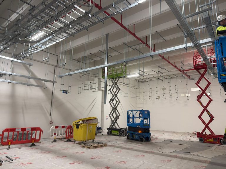 RAM project: Cable ladders and trays suspended above installation crews in Frankfurt