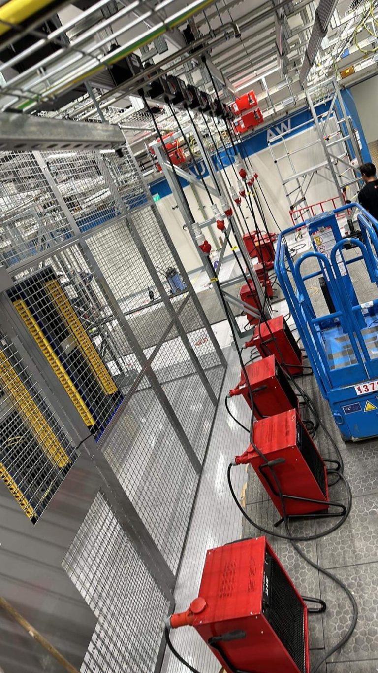 RAM project: Electrical work area with overhead cable trays, temporary equipment and access lift