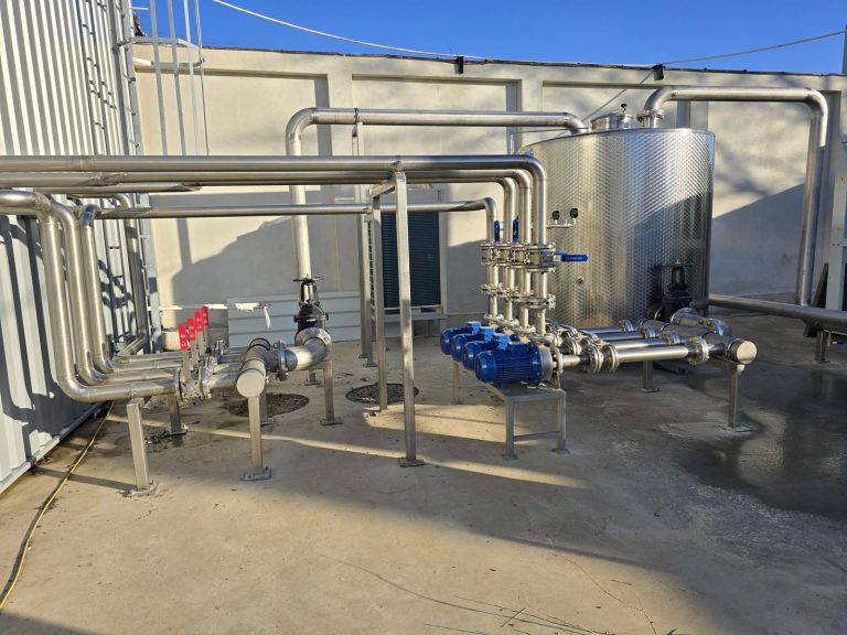 RAM project: Outdoor stainless steel pipework, pumps and a storage tank at the winery