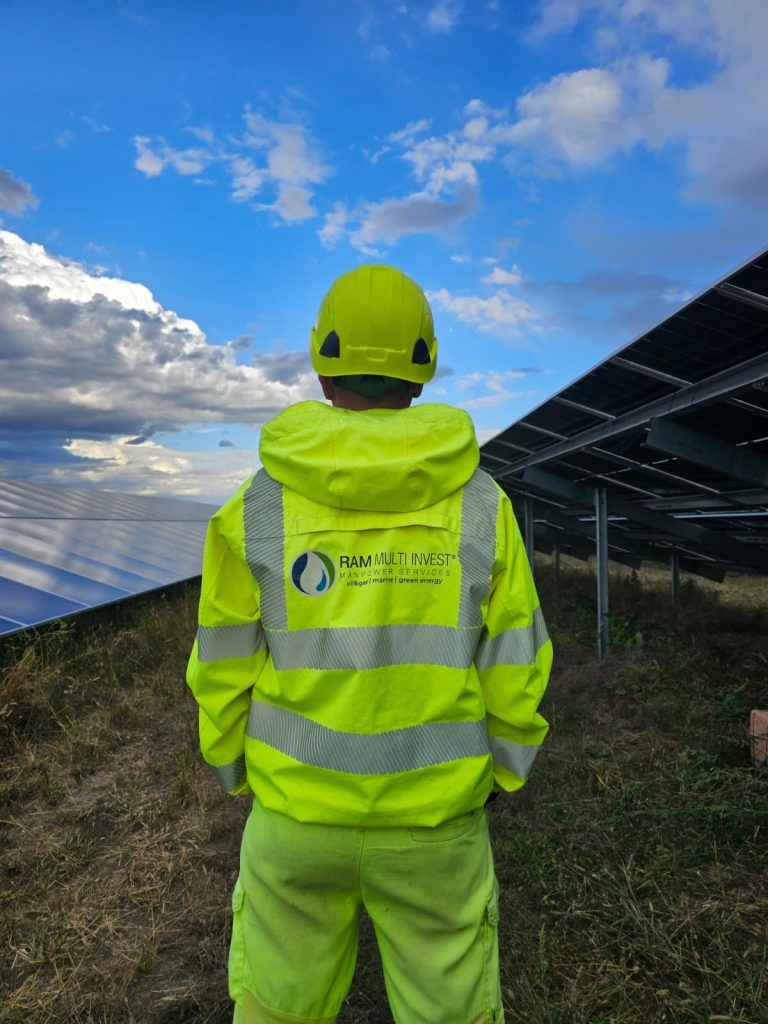RAM branded workwear beside photovoltaic panels
