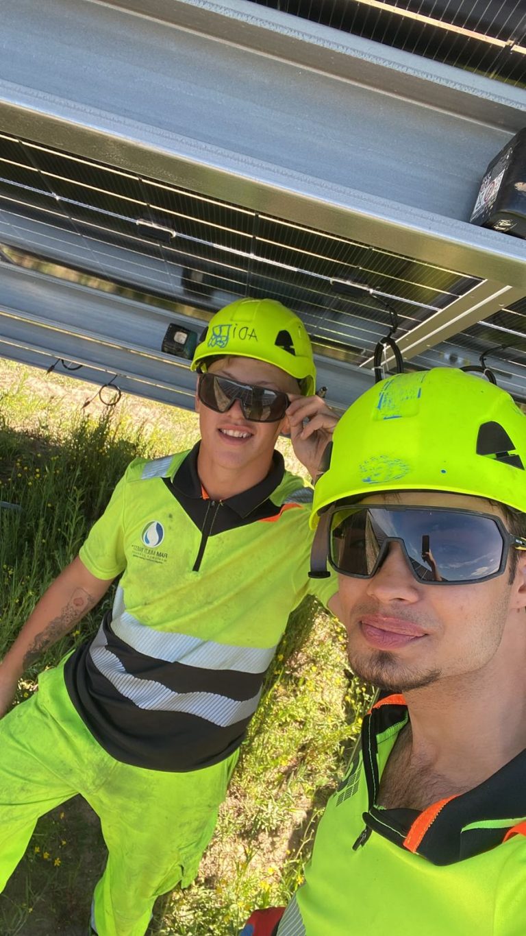 RAM team members beneath solar panels