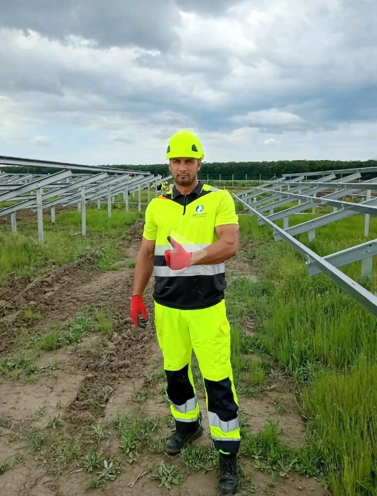 RAM worker among steel solar panel support structures