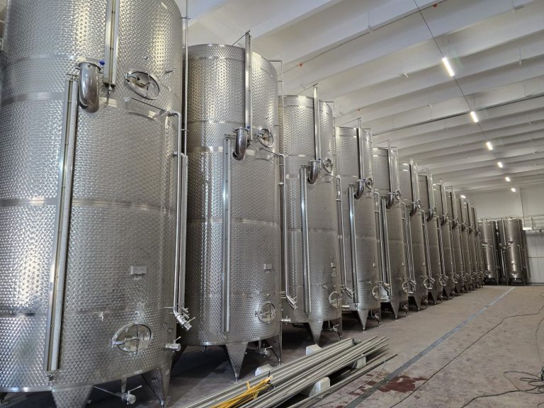 RAM project: Row of stainless steel winery storage tanks in Romania