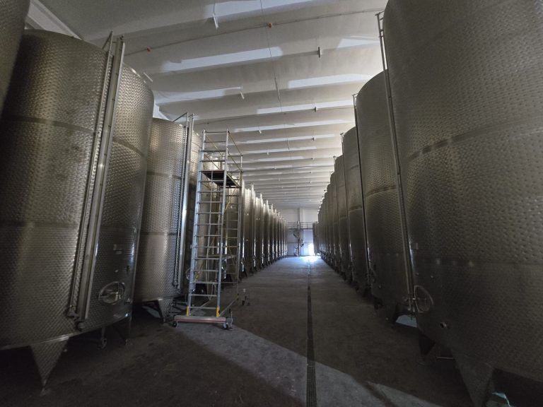 RAM project: Rows of winery storage tanks with a mobile access tower