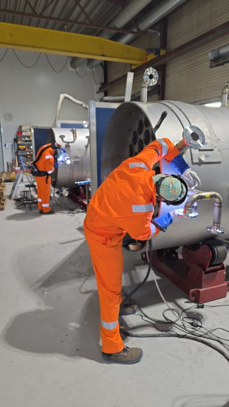 RAM project: Welders working on cylindrical desalination tanks in the workshop