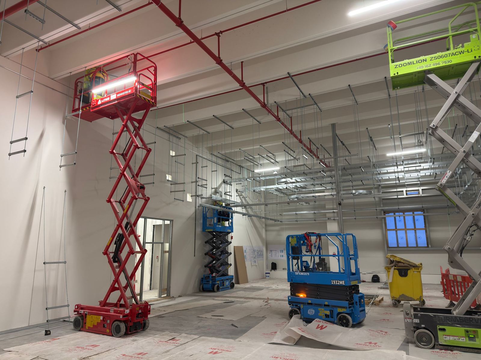 RAM installation teams working on suspended cable containment supports at a data center in Frankfurt, Germany